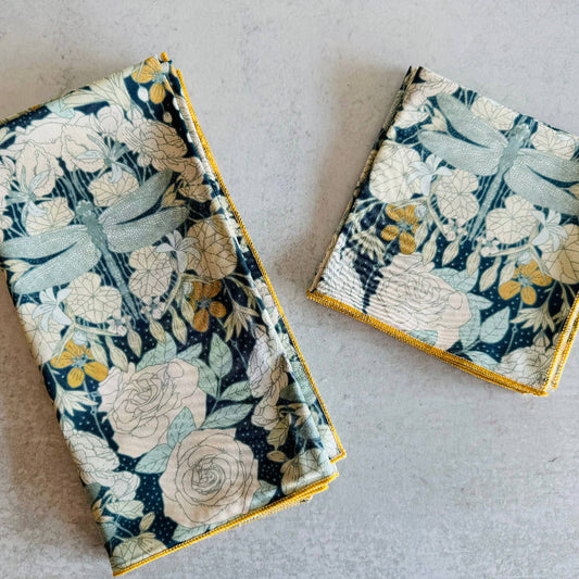 Two floral-patterned fabric items on a light gray surface